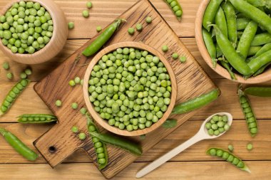 Ahşap zemin üzerinde taze bezelye ile kompozisyon, üst görünüm