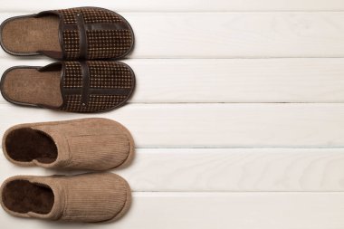 Man's slippers on wooden background, top view