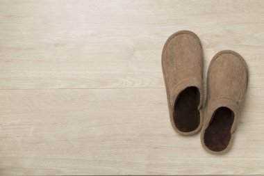 Man's slippers on wooden background, top view