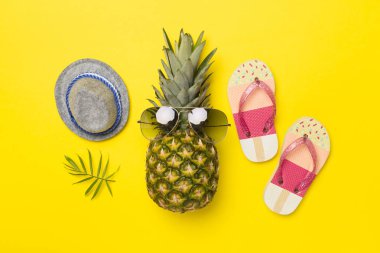 Güneş gözlüklü yaratıcı ananas hipster renkli arka plan, üst görünüm