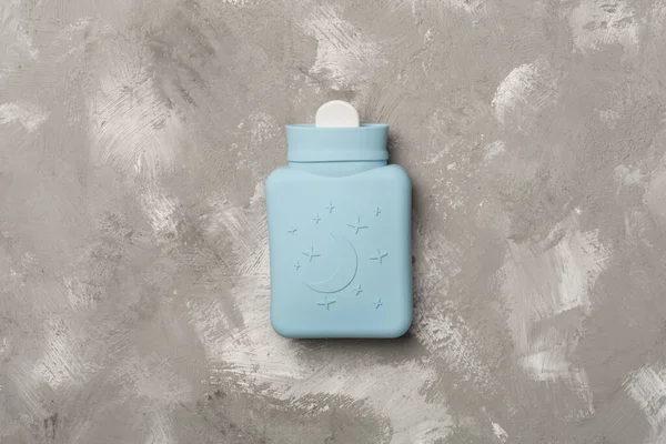 Small silicone water warmer bag on concrete background.