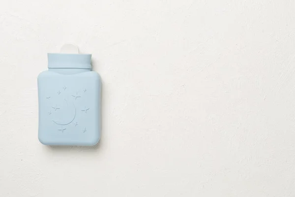 Small silicone water warmer bag on concrete background.
