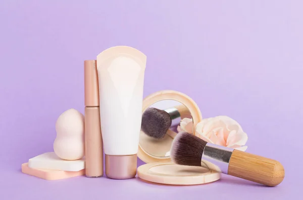 Composition with makeup products for skin tone on color background