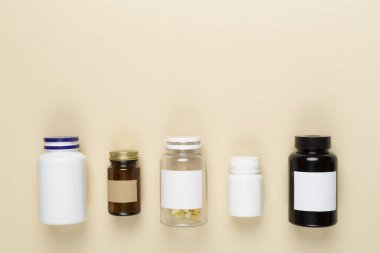 Renkli arka planda vitaminleri olan plastik şişeler, üst görünüm