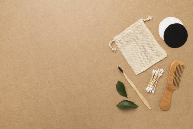 Flat lay with natural biodegradable accessories on wooden background, top view