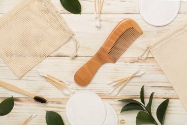 Flat lay with natural biodegradable accessories on wooden background, top view
