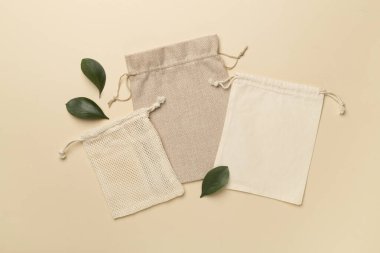 Small eco sacks with green leaves color on background. Top view