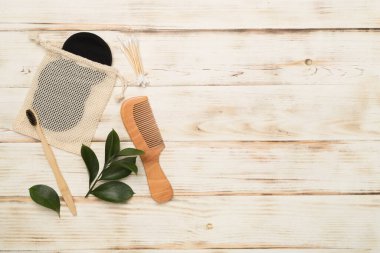 Flat lay with natural biodegradable accessories on wooden background, top view