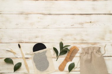 Flat lay with natural biodegradable accessories on wooden background, top view
