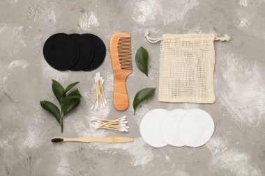 Flat lay with natural biodegradable accessories on concrete background, top view