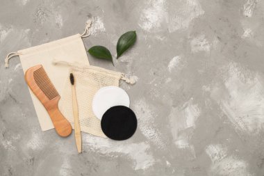 Flat lay with natural biodegradable accessories on concrete background, top view
