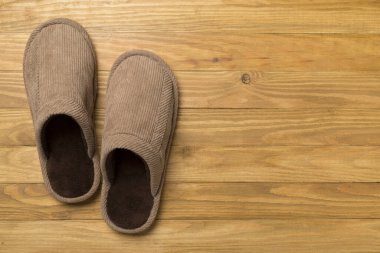 Man's slippers on wooden background, top view