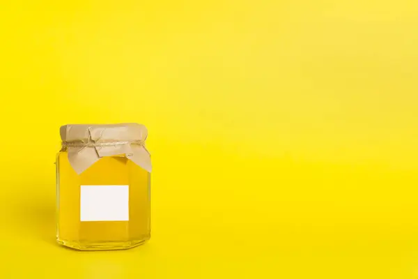 Jar with honey on color background. Mock up design