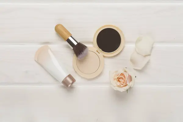 Composition with makeup products for skin tone on wooden background, top view