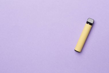 Disposable electronic cigarette on color background, top view