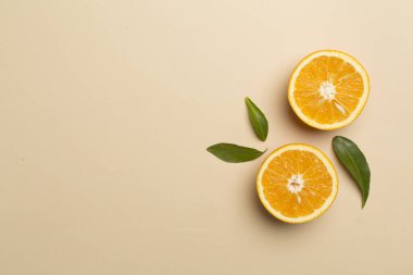 Flat lay with fresh oranges and leaves on color background.