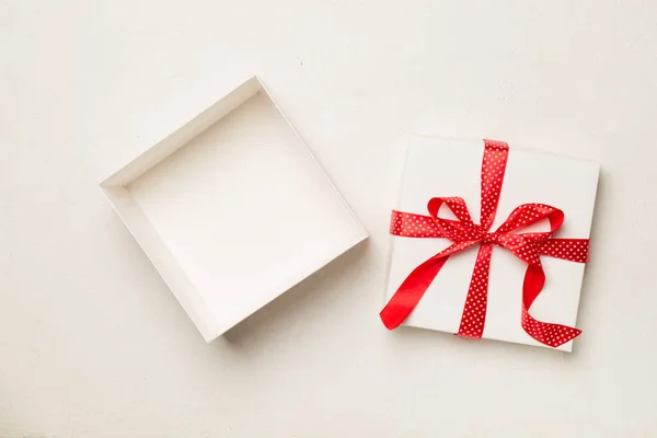 Open gift box on wooden background, top view