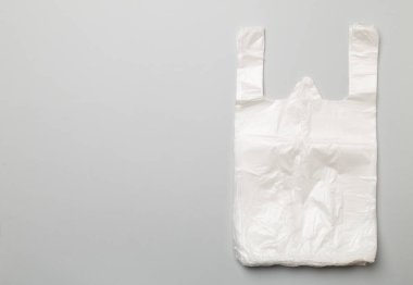 Plastic bag on color background, top view