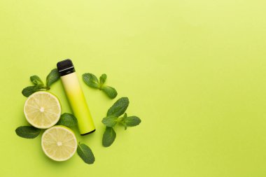 Disposable electronic cigarettes with fruits on color background, top view