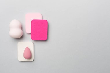 Beauty blenders on color background, top view