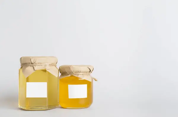 Jars with different honey on table. Mock up design
