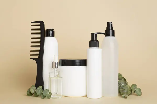 Professional hair care products with comb on table