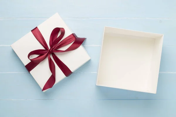 Open gift box on wooden background, top view. Mock up for design