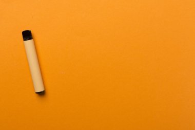 Disposable electronic cigarette on color background, top view