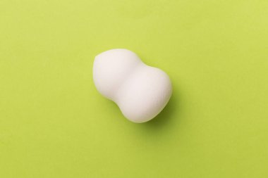 Beauty blender on color background, top view