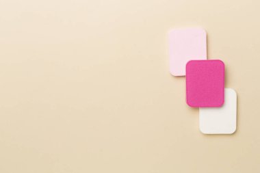 Beauty blenders on color background, top view