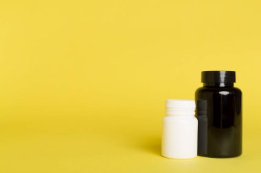 Renk arkaplanındaki vitaminler için plastik şişeler