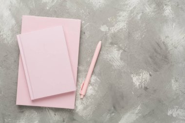 Beton zemin üzerinde kırtasiye malzemesi olan defterler, üst görünüm