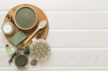 Ahşap arka planda kozmetik kil ve spa ürünleri ile kompozisyon, üst görünüm