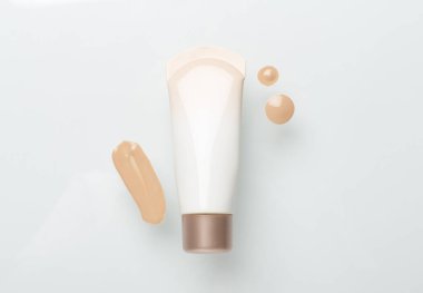 Renk arkaplanında makyaj temeli olan kompozisyon, üst görünüm