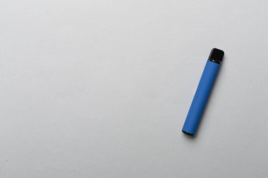 Disposable electronic cigarettes on color background, top view