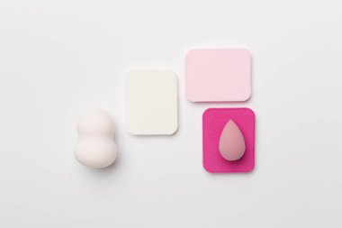 Beauty blenders on color background, top view