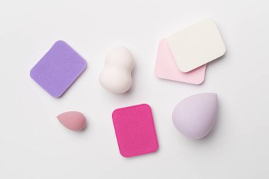 Beauty blenders on color background, top view