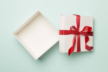 Open gift box on color background, top view