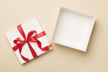 Open gift box on color background, top view