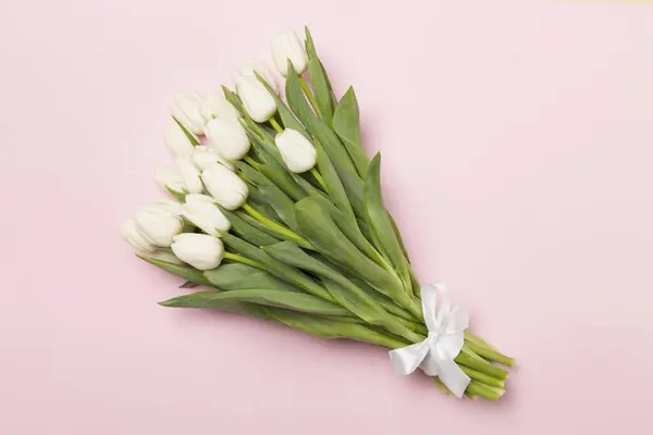 stock image White tulip bouquet on color background, top view
