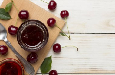 Tahta arka planda kiraz reçeli ile yassı yatıyordu