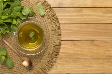 Ahşap arka planda taze nane çayı, üst manzara.