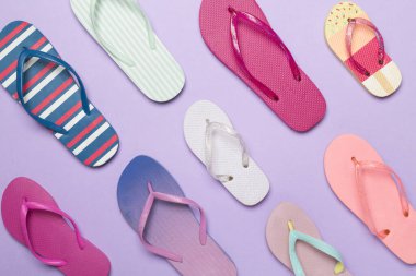 Renk arkaplanı ve üst görünümde birçok parlak parmak arası terlik