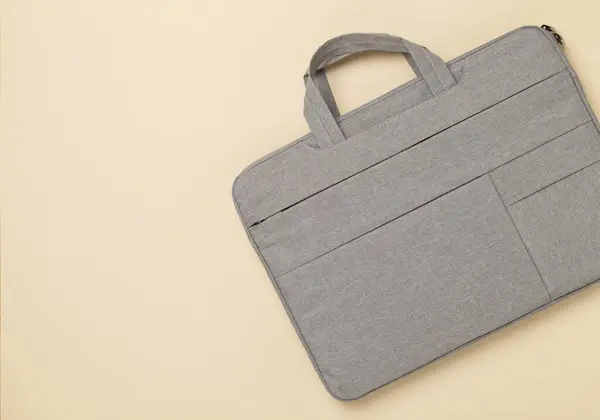 Grey stylish laptop bag on color background,top view