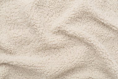 Arka plan olarak bej rengi oyuncak ayı kumaşı, üst görünüm