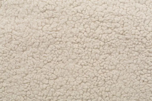 Arka plan olarak bej rengi oyuncak ayı kumaşı, üst görünüm