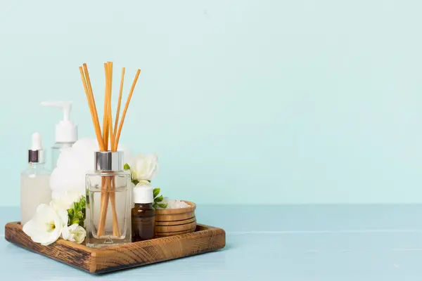 stock image Spa composition with freesia flower and aroma diffuser on wooden table