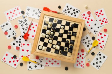 Different board games on color background, top view