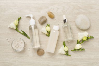 Tahta arka planda kaplıca ürünleri ve çiçeklerle yatıyordu