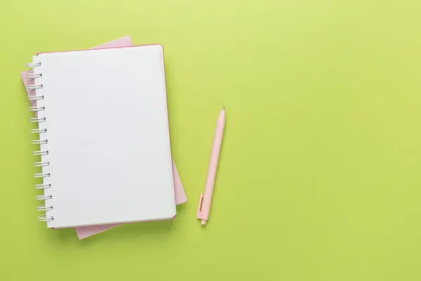 Renk arkaplanı ve üst görünümü üzerine kırtasiye içeren defter
